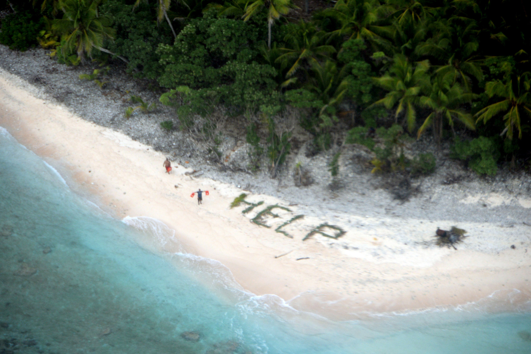 U.S. Navy rescues 3 from deserted island who spelled 'help' on beach