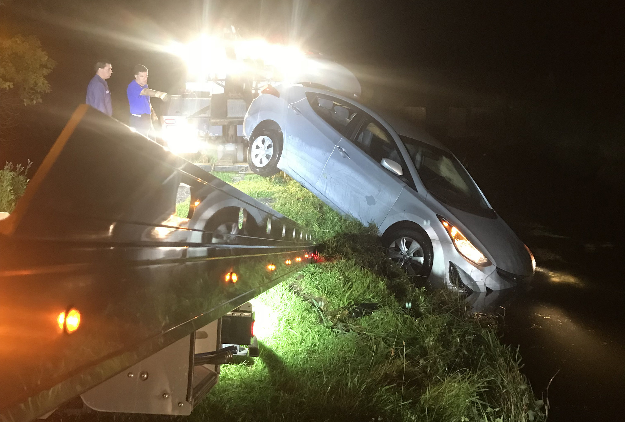 A car sank in a fish hatchery and the driver sat on top awaiting rescue. She's now charged with DWI.